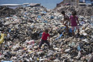 File - Palestinian kids sort through trash at a landfill in Nuseirat refugee camp, Gaza Strip, Thursday, June 20, 2024. Israel's war in Gaza has decimated the strip's sanitation system while simultaneously displacing the vast majority of the population, leaving many Palestinians living in tent camps nearby water contaminated with sewage and growing piles of garbage.
